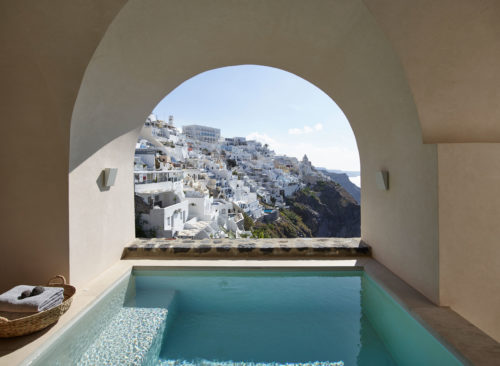 The master bedroom offering direct access to the private veranda with the plunge pool and sunbeds from where the views to the caldera and the volcanic islands are simply breath-taking.